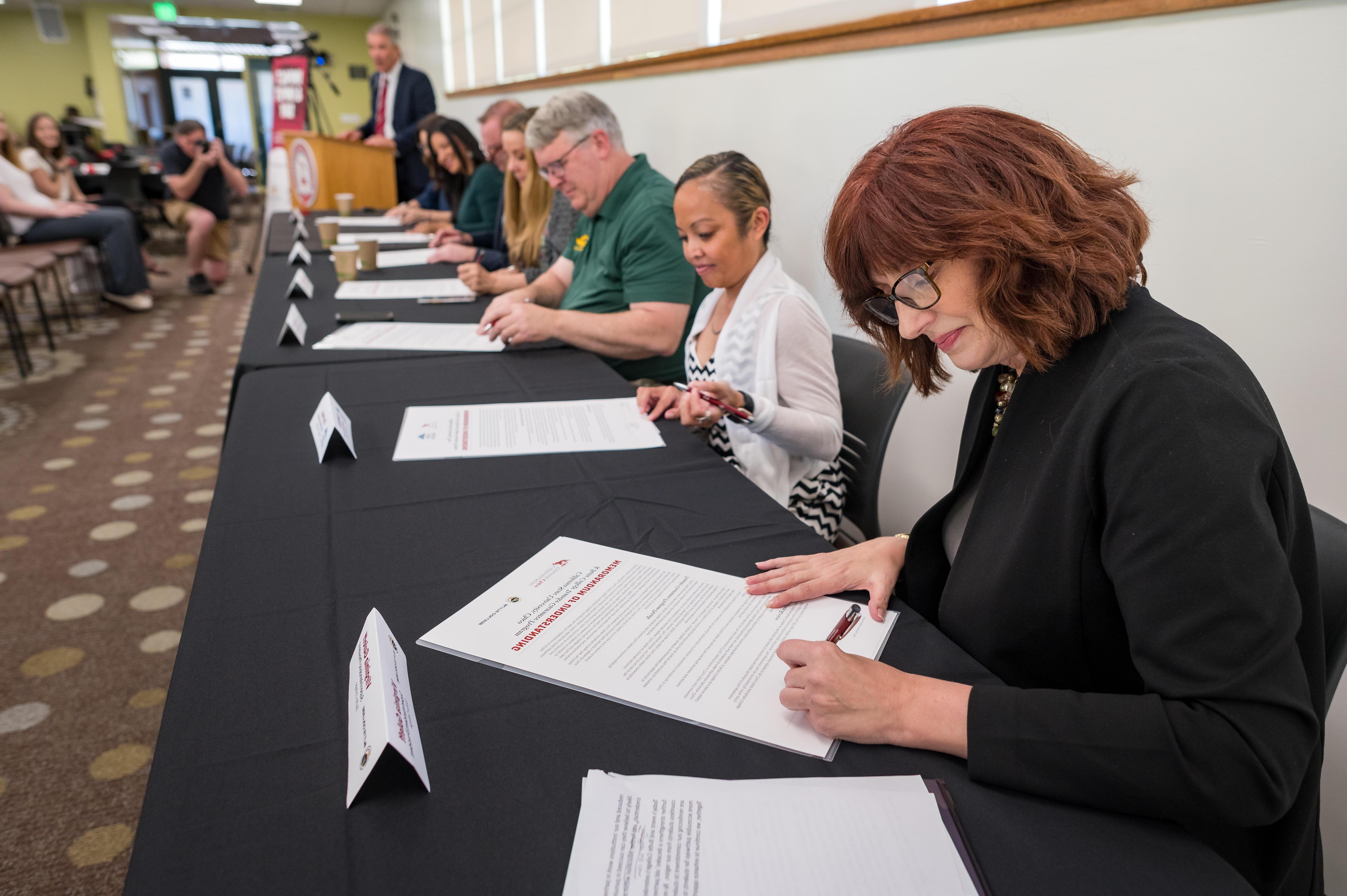 Butte College President Virginia Guleffis shown signing an MOU.